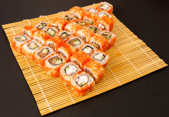 Set - sushi, rolls, sashimi on the mat