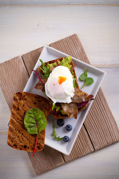 Egg, Bacon, Smashed White Bean And Avocado On Toast. Sandwich