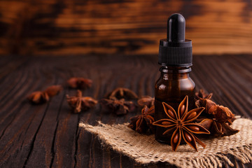 essential oil of the anise stars on a dark rustic background
