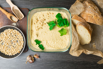 Hummus or houmous, appetizer made of mashed chickpeas with tahini, lemon, garlic, olive oil,...