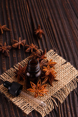 essential oil of the anise stars on a dark rustic background