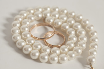 Two golden wedding rings with Pearl necklace