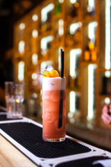 Colorful orange cocktail in bar