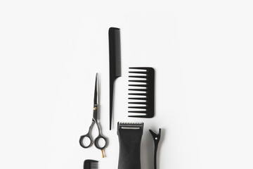 flat lay with hair machine and hairdressing tools, on white