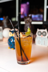 Colorful orange cocktail with mint in bar