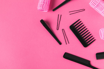 flat lay with curlers and hairdressing tools, on pink