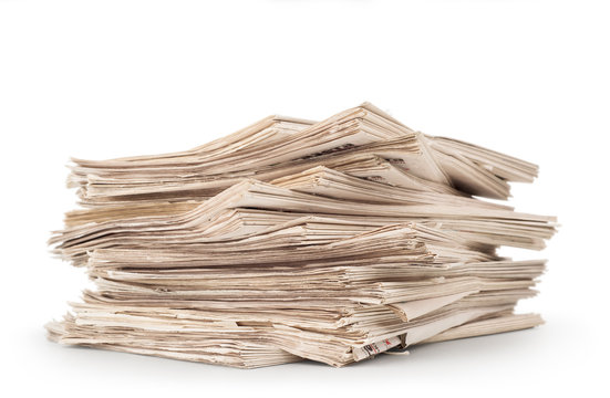 A stack of old newspapers isolated on white background