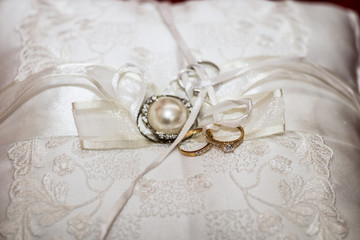 golden rings and cloths flower of white color with  white back ground 