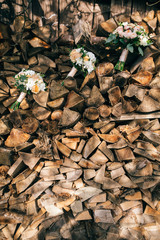 Bouquet of flowers for the bride and bridesmaids on her wedding day paired with a wood backdrop. Wedding accesories.