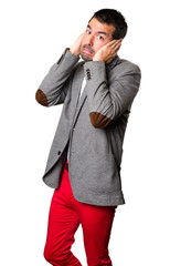 Handsome man covering his ears on isolated background