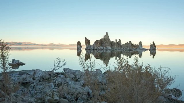 Mono lake tufas with reflection in calm water close-up on sunrise.