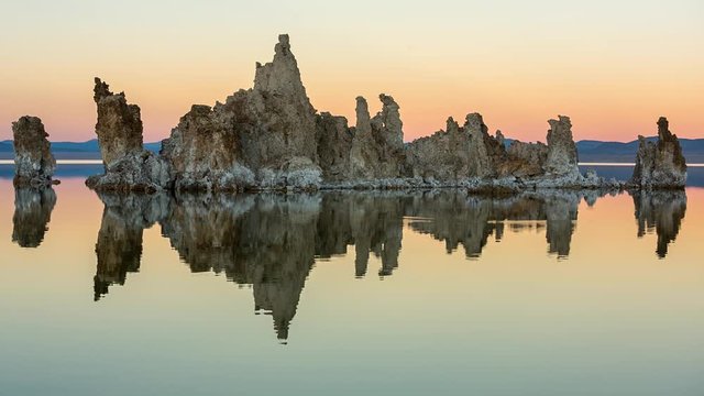 Mono lake tufas with reflection in calm water close-up on sunset.