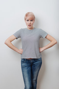 Angry attractive young woman with hands on hips