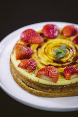 Homemade cream layer cake, fresh, colorful, and delicious dessert with juicy strawberries.