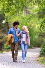 Young cheerful couple walking in the park