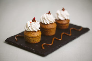 Three small cakes on a green background.