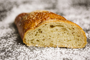 Sugar bun on a wooden background.
