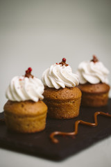 Three small cakes on a green background.