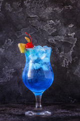 Blue Curacao cocktail decorated with fruit.