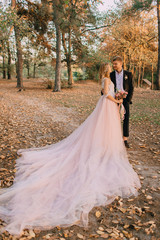 Fototapeta premium portrait of happy newlyweds during a walk in the forest