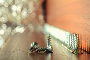 Fototapeta premium number of screws on the wooden background