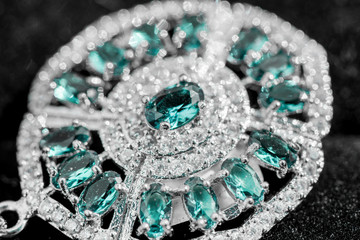 Macro shot of silver pendant with zircon stone and topaz on black background. Beautiful, handmade and expensive jewelry. Meditative, calming, healing and powerful crystals 