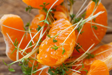 Fresh cutted cress young sprouts citrus orange salad close up selected focus
