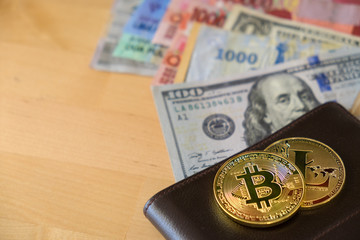 Golden Bitcoin and Litecoin Cryptocurrency digital payment system with  wallet and dollar banknotes on wooden table background. Cryptocurrency Trading concept