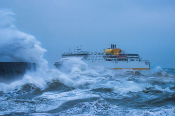 Storm Force. Ship struggling to make the safety of the harbour. Newhaven East Sussex, UK