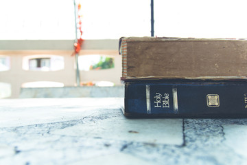 The Holy Bible " The Words of God" on the marble table .Vintage Tone.