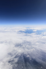 Blue sky and white clouds from window of airplane, aerial photography