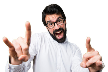 Handsome man with glasses making horn gesture
