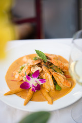 Thai Chicken Satay with Sauce Diner on a White Plate with an Orchid