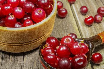 Still-life with cranberries on a wooden table