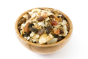 Muesli and dried fruit in wooden bowl isolated on white background.