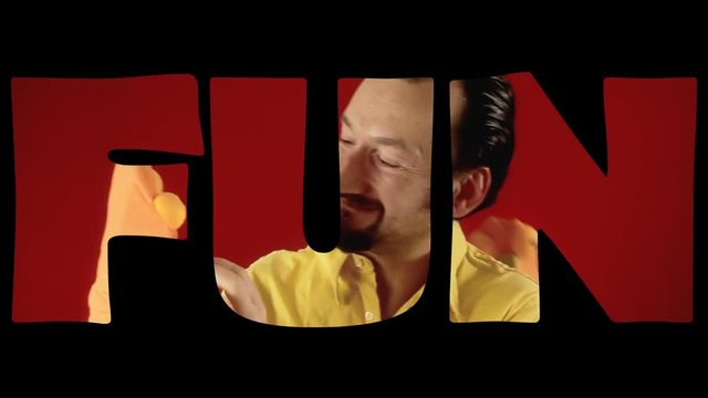 Cutout of the word Fun over the scene of a grownup man playing with two handmade sock puppets.
