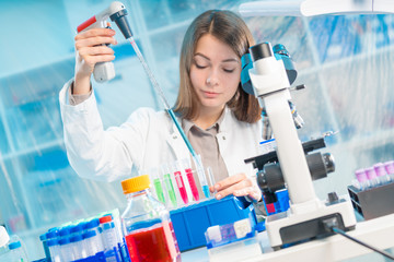 Chemical laboratory scientist woman working with pipette