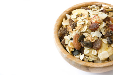 Muesli and dried fruit in wooden bowl isolated on white background. Copyspace