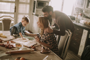Happy family making pasta in the kitchen at home
