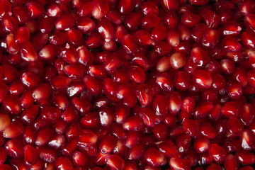Delicious red ripe juicy pomegranate seed background texture