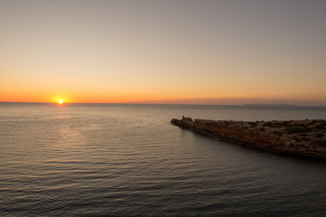 Fototapeta na wymiar Sunrise at the Cala Sa Punta in Ibiza