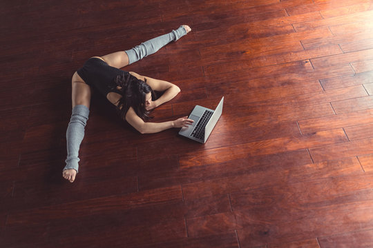 Young ballerina with laptop