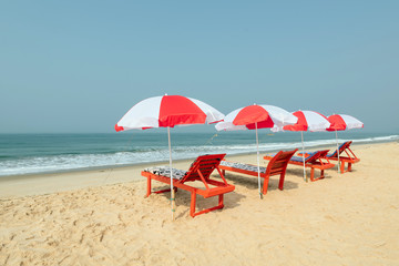 Sunbeds under tent on beach.