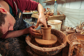Potter at work. Workshop place.