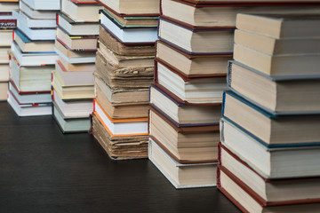 Many books in a bookstore or library on wooden background with copy space
