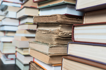 Many books in a bookstore or library on wooden background with copy space