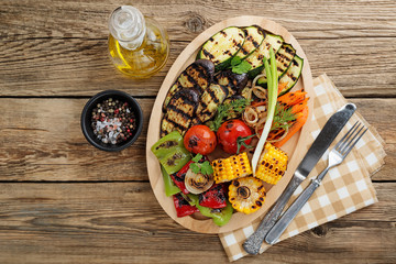 Delicious grilled vegetables on wooden background. top view