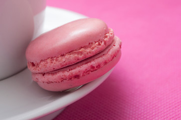 closeup of french macaron pastry on pink background
