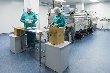 Pharmaceutical factory workers in sterile environment