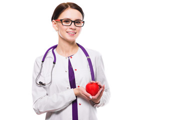 Young beautiful female doctor holding heart in her hand on white background